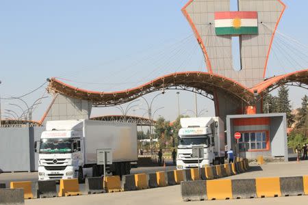 Trucks laden with goods from Turkey are seen at the checkpoint of Ibrahim al-Khalil in Zakho, Iraq October 11, 2017. REUTERS/Ari Jalal