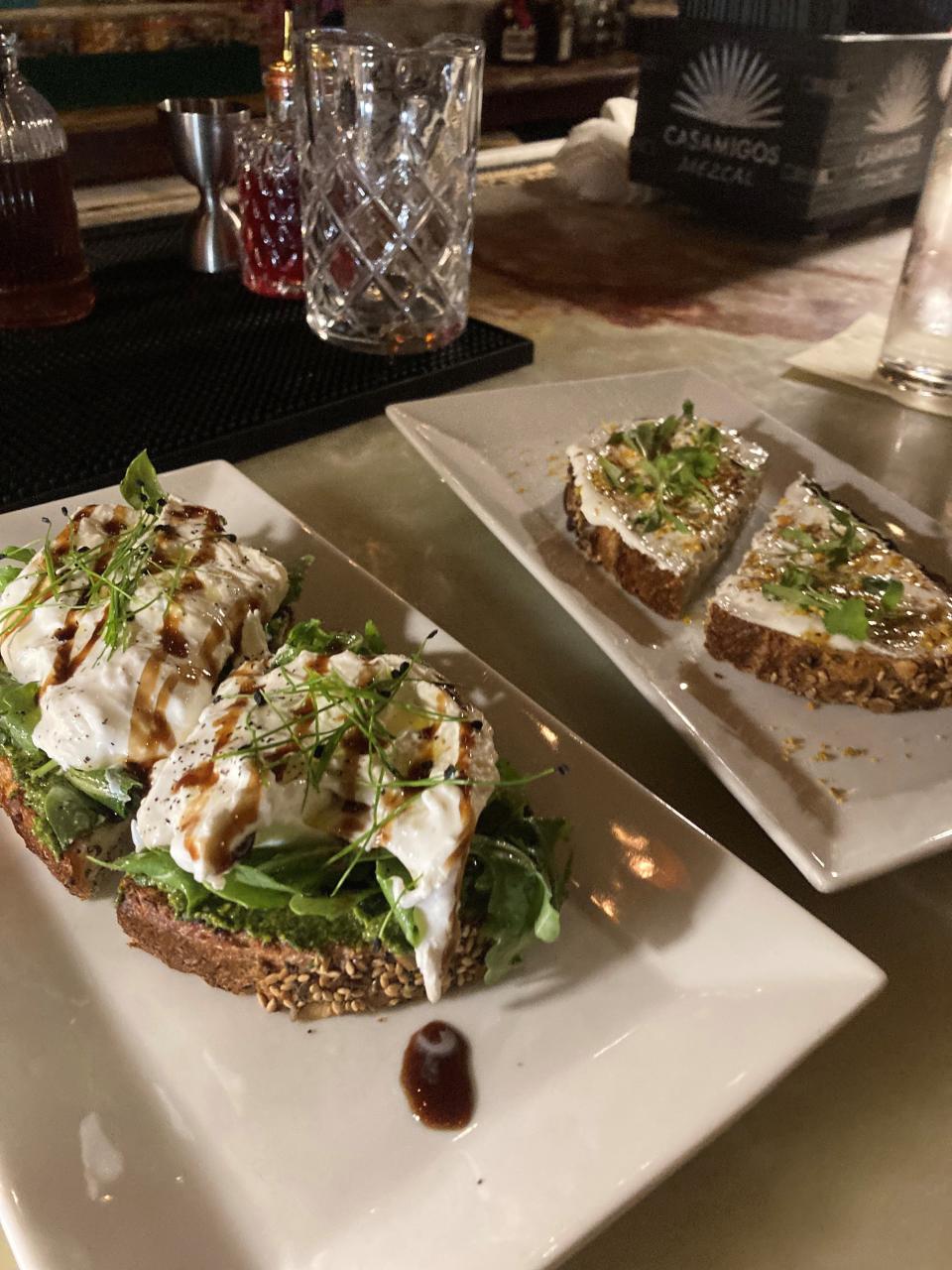 Some of the food items on The Raconteur menu in Pleasantville include burrata bruschetta, on left and Labne toast,  right, with truffle honey, bee pollen, za'atar, and micro cilantro. Photographed Dec. 6, 2022