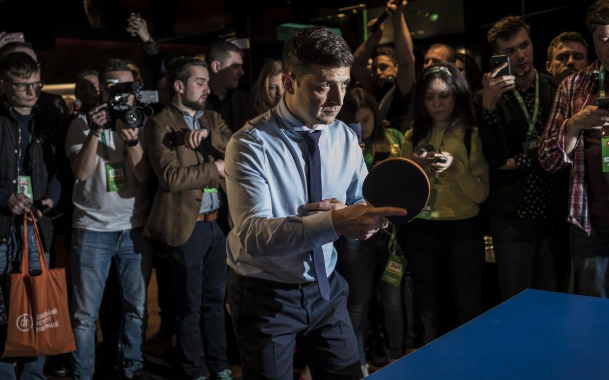 Volodymyr Zelenskiy, who won the first round, plays ping pong at his headquarters on Sunday evening - Getty Images Europe