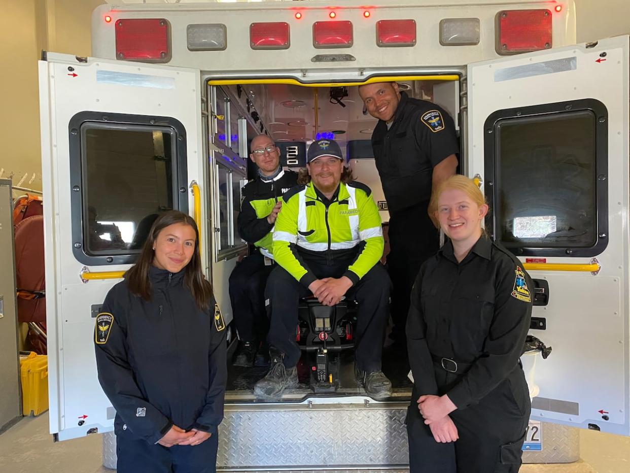 Dawson City, Yukon's Emergency Medical Services team sitting in the community's new ambulance.  (Chris MacIntyre/CBC - image credit)