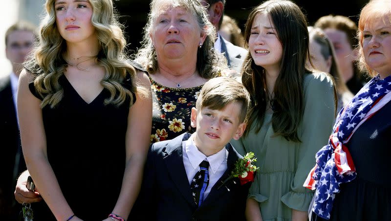 Family members of deputy Jennifer Turner, including her three children, June, Bryce and Ashlyn, watch as their mother’s urn is placed into a hearse following the memorial service for Turner and Cpl. Steven Lewis at the Dee Events Center in Ogden on Friday, July 14, 2023. Lewis and Turner were killed in a wrong-way crash near the intersection of South Weber Drive and Canyon Meadows Drive on Monday, July 3.
