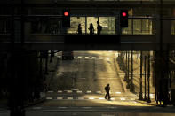 FILE - In this April 8, 2020, file photo pedestrians make their way through a deserted downtown Kansas City, Mo., on what would normally be a busy workday morning. There are emerging signs that any recovery will fail to match the speed and severity of the economic collapse that occurred in just a few weeks. (AP Photo/Charlie Riedel, File)