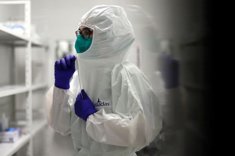 A nurse puts on her protection suit before entering a COVID-19 patient's ward amid the coronavirus disease (COVID-19) pandemic in Cascais