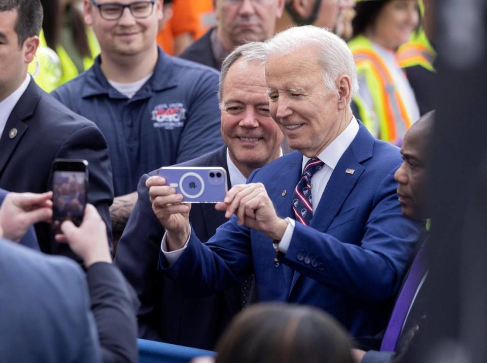 President Joe Biden takes a selfie with Wolfspeed CEO Gregg Lowe on Tuesday, March 28, 2023, in Durham, N.C.