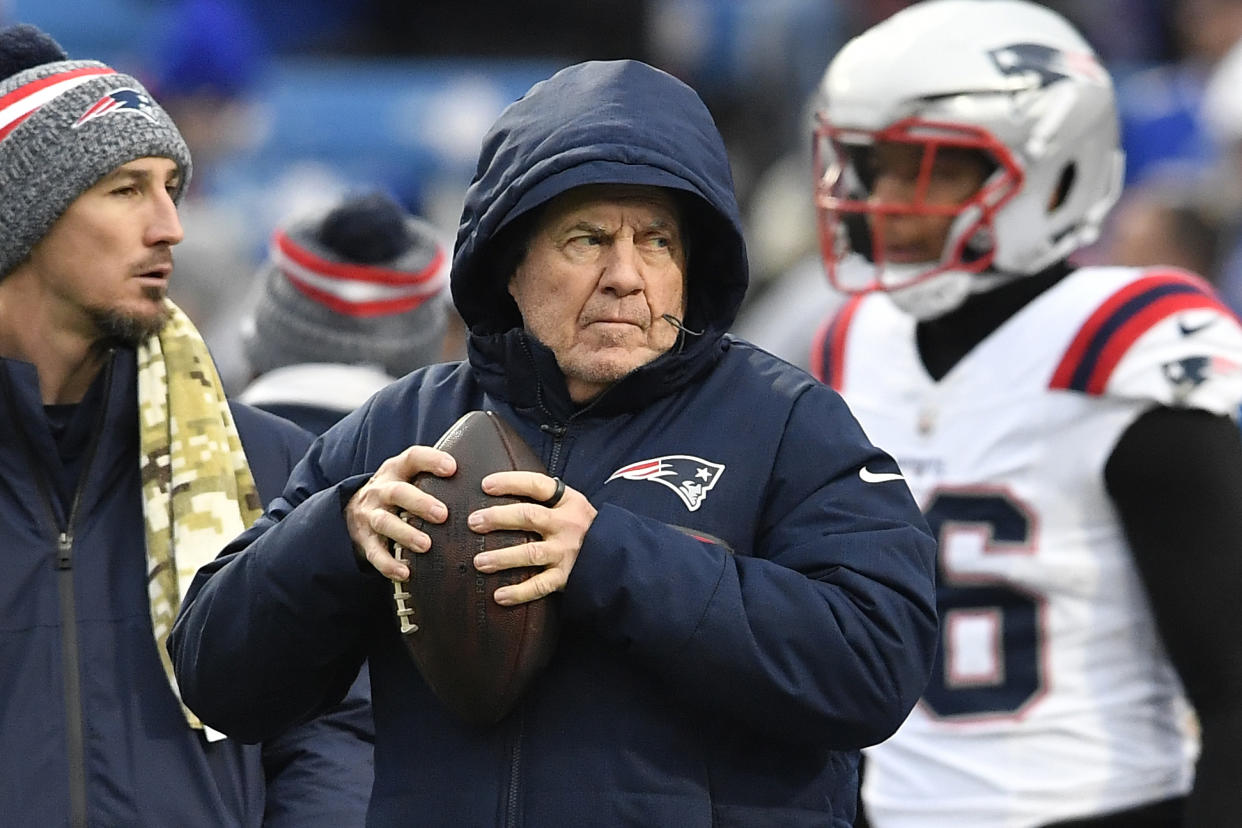 New England Patriots head coach Bill Belichick, center, watches warmups before an NFL football game against the Buffalo Bills in Orchard Park, N.Y., Sunday, Dec. 31, 2023. (AP Photo/Adrian Kraus)
