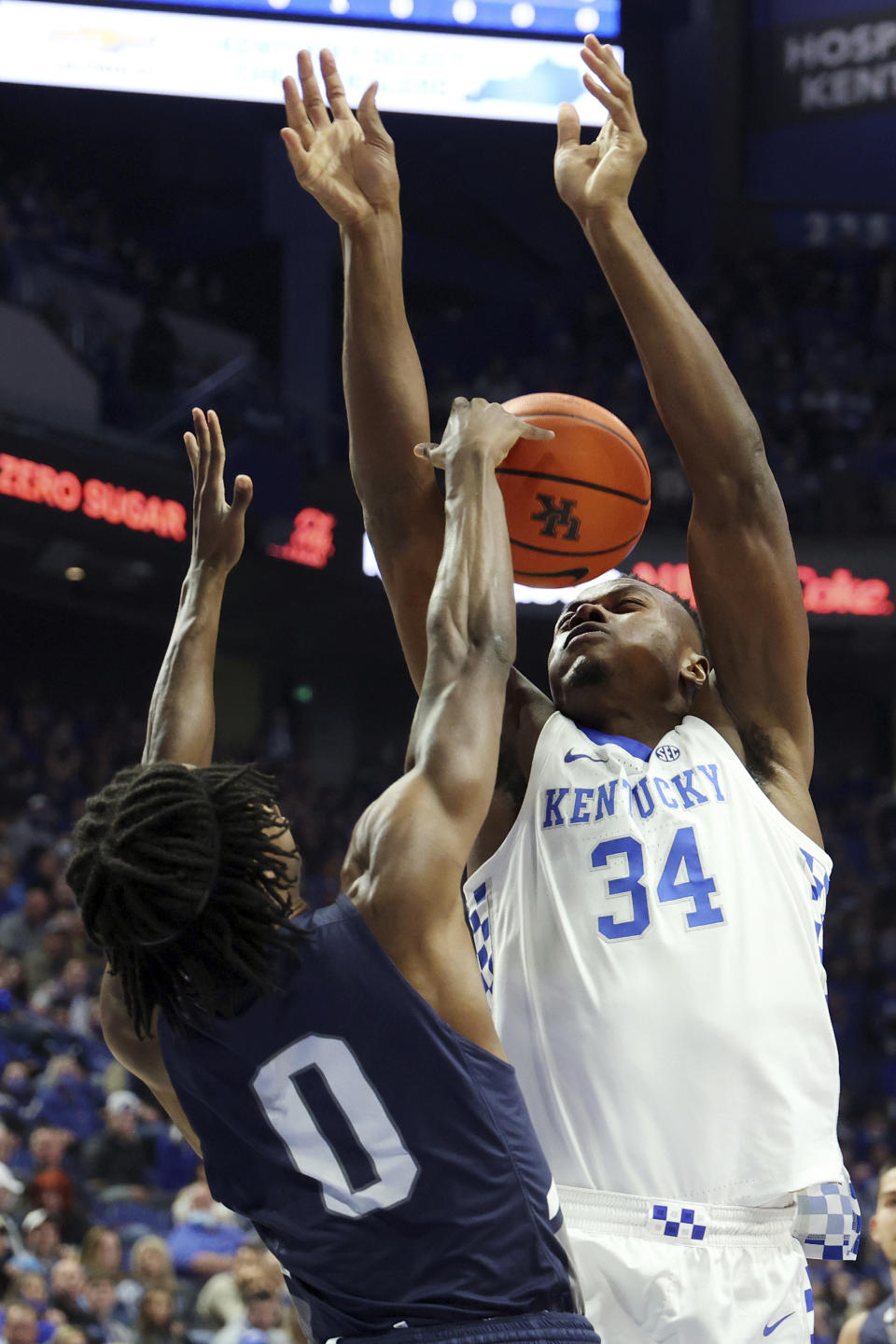 Kentucky's Oscar Tshiebwe (34) is fouled by North Florida's Emmanuel Adedoyin (0) during the first half of an NCAA college basketball game in Lexington, Ky., Friday, Nov. 26, 2021. (AP Photo/James Crisp)