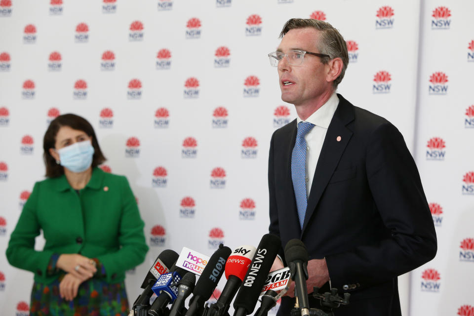 NSW Treasurer Dominic Perrottet speaks as NSW Premier Gladys Berejiklian looks on during a COVID-19 update and news conference on July 28, 2021 in Sydney, Australia