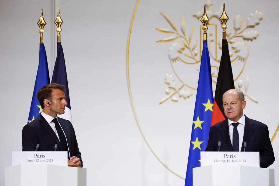 French President Emmanuel Macron, left, listens to German Chancellor Olaf Scholz during a joint press conference with Polish President Andrzej Duda, Monday, June 12, 2023 at the Elysee palace in Paris. Emmanuel Macron, German Chancellor Olaf Scholz and Polish President Andrzej Duda meet in Paris for talks focusing on military support for Ukraine's counteroffensive and future security guarantees to be given to the country, ahead of a NATO summit in July. (Sarah Meyssonnier, Pool via AP)