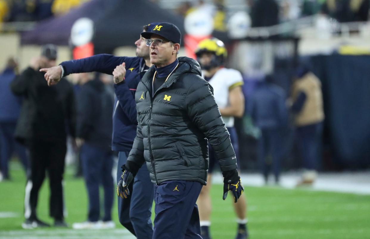 Michigan Wolverines head coach Jim Harbaugh watches his team warm up before action against the Michigan State Spartans Saturday, Oct 21, 2023 at Spartan Stadium in East Lansing.