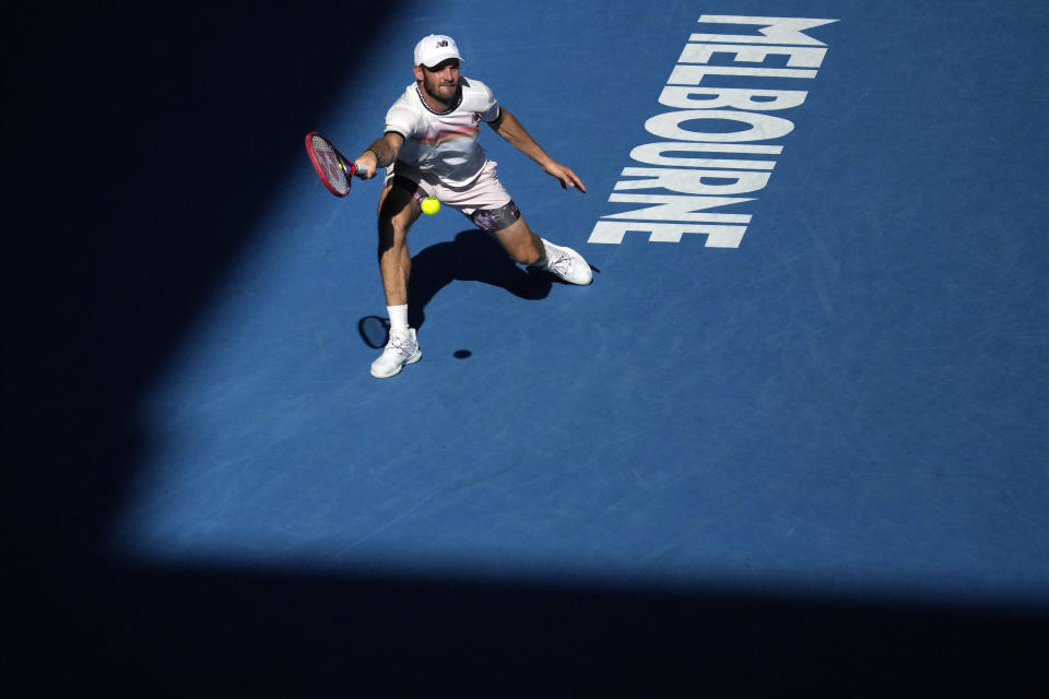 Tommy Paul of the U.S. plays a forehand return to compatriot Ben Shelton during their quarterfinal match at the Australian Open tennis championship in Melbourne, Australia, Wednesday, Jan. 25, 2023. (AP Photo/Dita Alangkara)