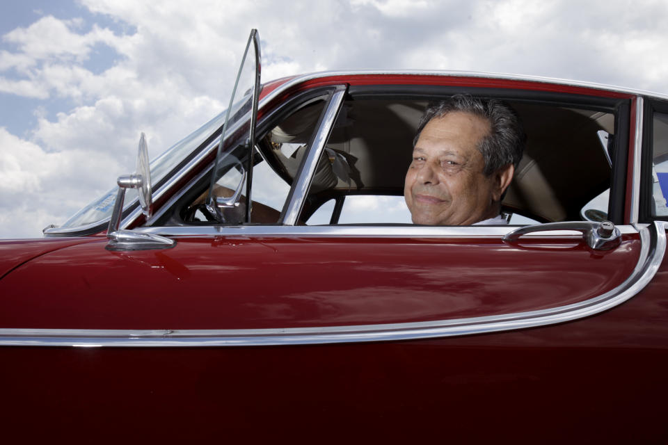 Irv Gordon poses for a picture in his Volvo P1800 in Babylon, N.Y., Monday, July 2, 2012. Gordon's car already holds the world record for the highest recorded milage on a car and he is less than 40,000 miles away from passing three million miles on the Volvo.  (AP Photo/Seth Wenig)