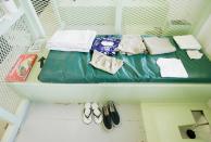 GUANTANAMO BAY, CUBA - MAY 09: (IMAGE REVIEWED BY U.S. MILITARY PRIOR TO TRANSMISSION) Clothes and slippers and board games that are given to detainee's sit in a cell of the Camp 2 cell block at Camp Delta May 9, 2006 in Guantanamo Bay, Cuba. Camp Delta was first occupied on April 28, 2002, when 300 detainees previously held at Camp X-Ray were transferred to Camp Delta. The rest of the detainees were moved on April 29. Camp X-Ray closed down on that same day. (Photo by Mark Wilson/Getty Images)