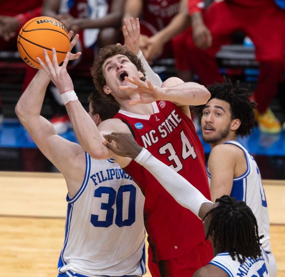 N.C. State’s Ben Middlebrooks (34) collides with Duke’s Kyle Filipowski (30) under the basket in the second half during the NCAA South Regional final on Sunday, March 31, 2024 at the American Airlines Center in Dallas, Texas.