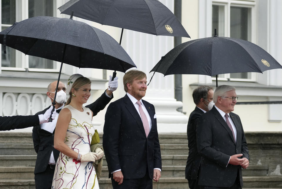 German President Frank-Walter Steinmeier, front right, welcomes Dutch King Willem-Alexander, center, and his wife Queen Maxima, front left, with military honors for a meeting in Berlin, Germany, Monday, July 5, 2021. The Royals arrived in Germany for a three-day visit that was delayed from last year because of the coronavirus pandemic. (AP Photo/Michael Sohn)