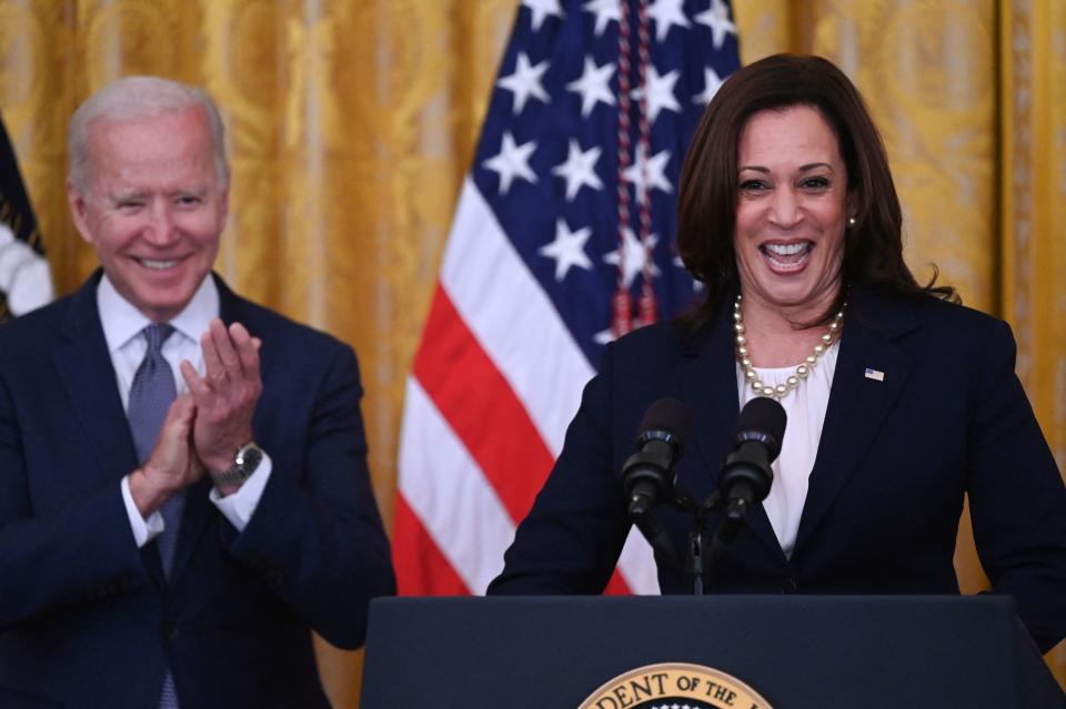 Vice President Kamala Harris looks jubilant, as President Biden claps.