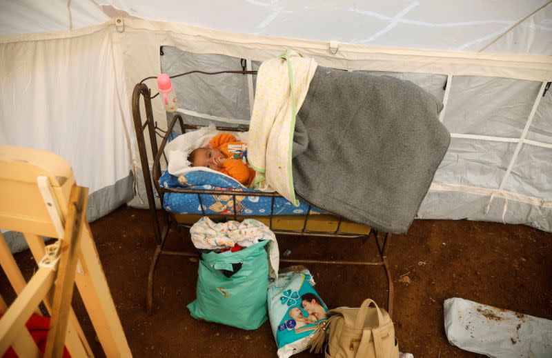 A Palestinian baby, whose family tented home was destroyed, lies on a bed in a tent in Khirbet Humsah in Jordan Valley in the Israeli-occupied West Bank