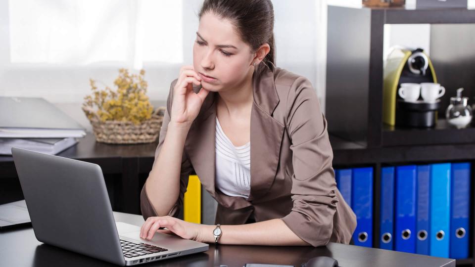 Elegant stressful business woman work on the notebook in the office.