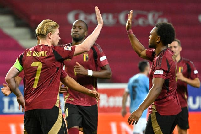 Belgium's Kevin De Bruyne, left, high-fives Lois Openda after scoring against Hungary