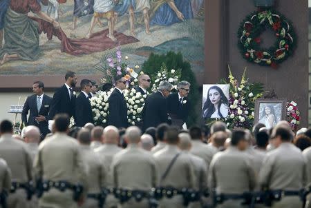 Pallbearers carry the casket of San Bernardino shooting victim Yvette Velasco during her memorial service in Covina, California, December 10, 2015. REUTERS/Mike Blake