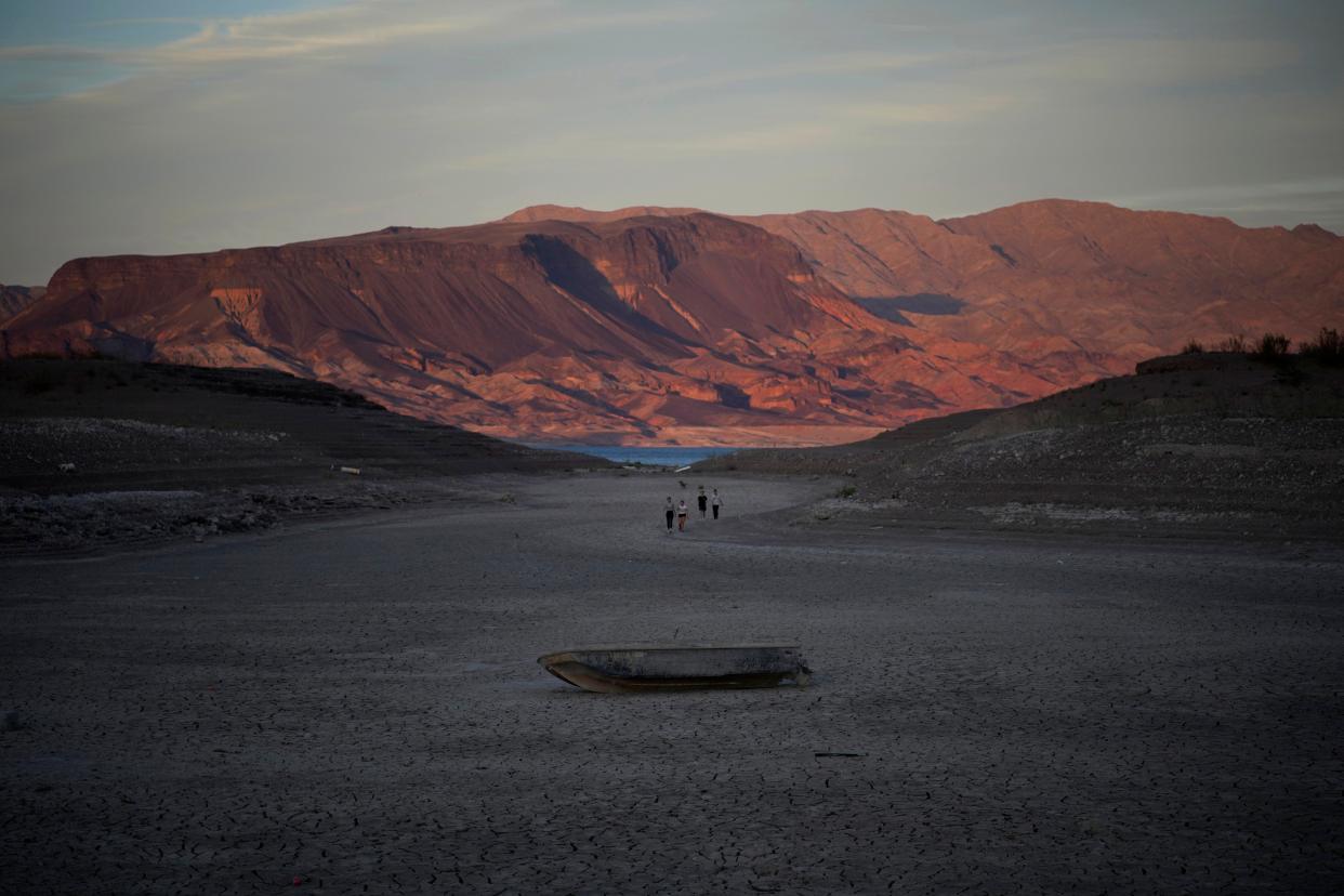 A formerly sunken boat sits on cracked earth hundreds of feet from what is now the shoreline on Lake Mead at the Lake Mead National Recreation Area, Monday, May 9 near Boulder City. Lake Mead is receding and Sin City is awash with mob lore after a second set of human remains emerged within a week from the depths of the drought-stricken Colorado River reservoir just a short drive from the Las Vegas Strip.