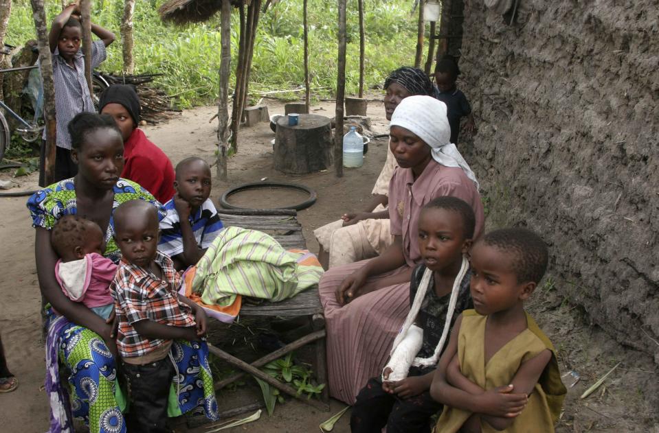 A family gathers in their home after an attack by gunmen in Hindi village, near Lamu