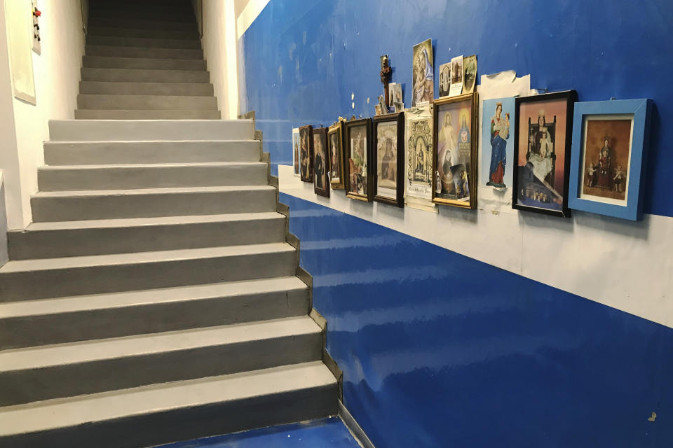 Saints icons are displayed on a wall before the stairway leading the field entrance of the San Paolo's stadium in Naples, Italy Tuesday, Sept. 17, 2019. Before he climbed the steps and emerged before the crowd, Maradona used to pray to the Madonna di Pompei and kiss the prayer card. (AP Photo/Andrew Dampf)
