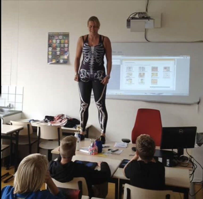 After taking her clothes off once during the lesson, Ms Heerkens decides to strip another layer, this time revealing the skeletal system. Photo: YouTube