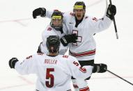 Switzerland's Nico Dunner (R) celebrates his goal against Canada with teammate Kevin Fiala and Mirco Muller (5) during the second period of their IIHF World Junior Championship ice hockey game in Malmo, Sweden, January 2, 2014. REUTERS/Alexander Demianchuk (SWEDEN - Tags: SPORT ICE HOCKEY)