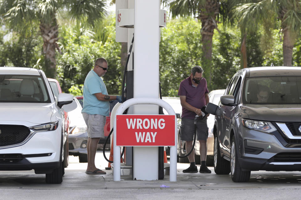 Drivers fuel up at BJ's in Boynton Beach, Fla., as they prepare for Hurricane Isaias on Friday, July 31, 2020. Isaias is forecasted to stay east of the coast but it will bring winds and possible coasting flooding. (Amy Beth Bennett/South Florida Sun-Sentinel via AP)