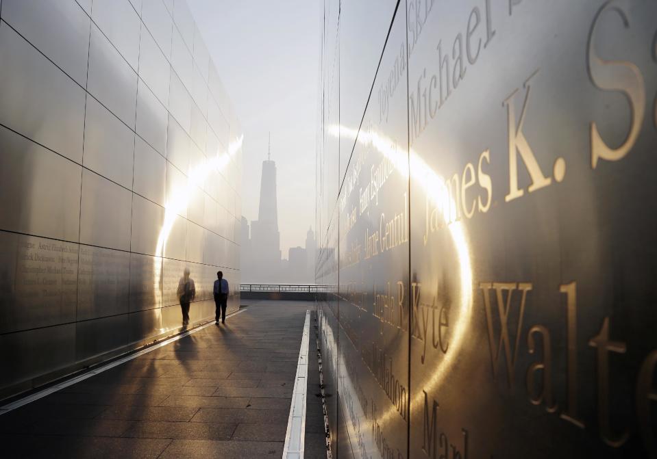 FILE - This Sept. 11, 2013 file photo shows a visitor walking through the "Empty Sky" memorial to New Jersey's victims of the Sept. 11, 2001 terrorist attacks in Jersey City, N.J. (AP Photo/Mel Evans, File)