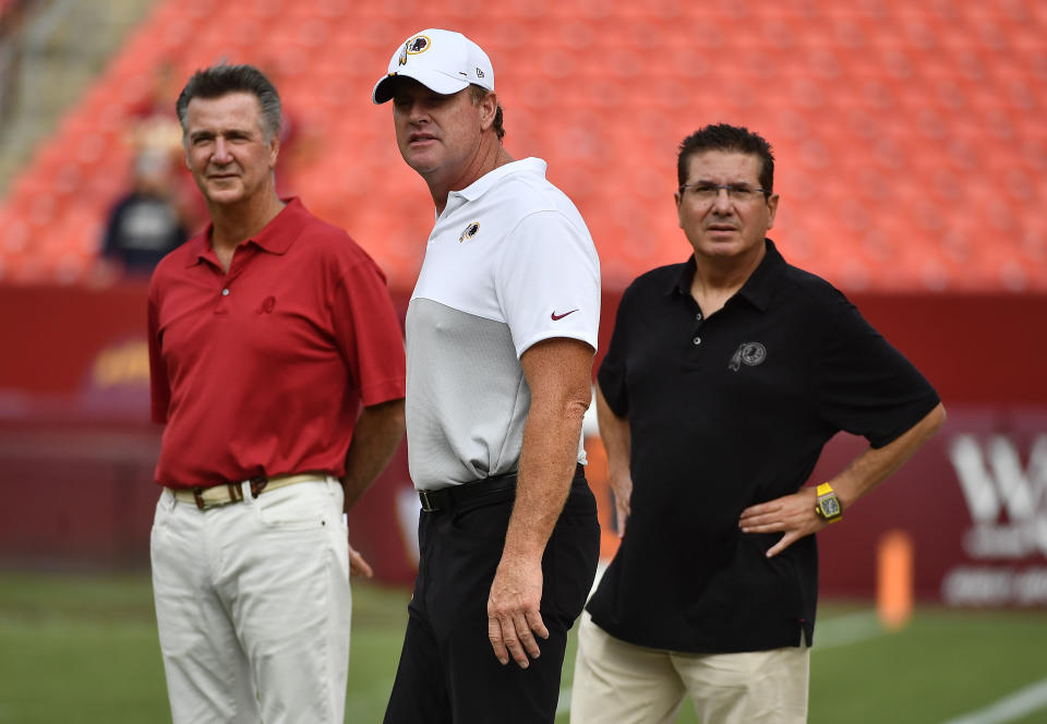 Aug 15, 2019; Landover, MD, USA; Washington Redskins president Bruce Allen (left) and head coach Jay Gruden (center) and team owner Daniel Snyder (right) look on from the field before a game against the Cincinnati Bengals at FedExField. Mandatory Credit: Brad Mills-USA TODAY Sports