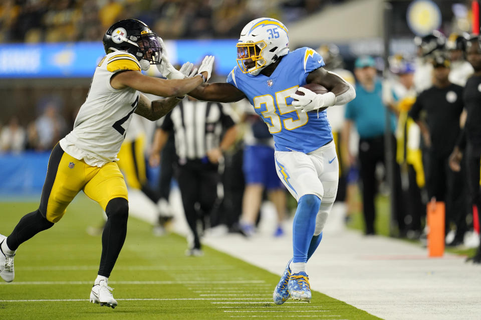 Los Angeles Chargers running back Larry Rountree III runs with the ball as Pittsburgh Steelers cornerback Tre Norwood defends during the second half of an NFL football game against the Pittsburgh Steelers Sunday, Nov. 21, 2021, in Inglewood, Calif. (AP Photo/Marcio Jose Sanchez)