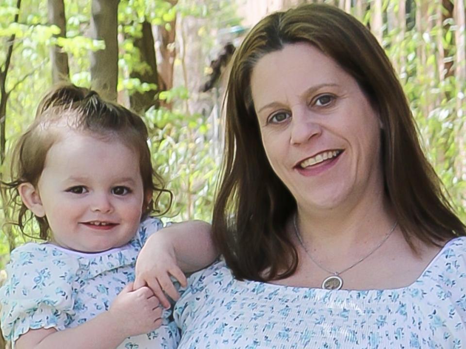 Mom Marie Brennan, who is expecting her third child any day now, holds her 22-months-old daughter, Annabel,