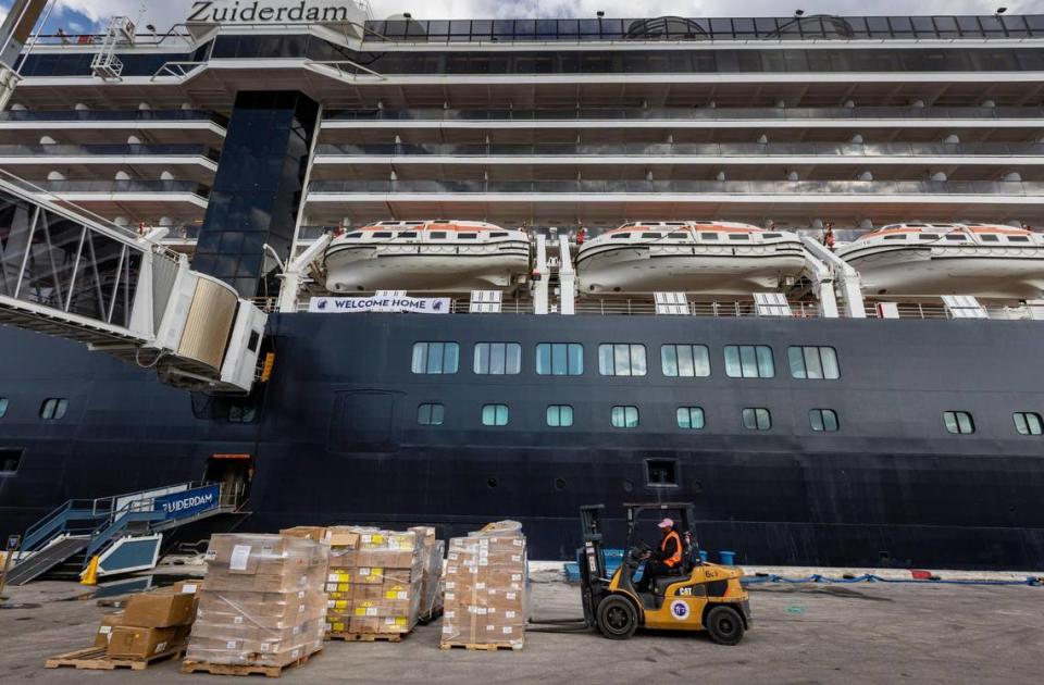 A worker loads boxes of supplies on Holland America’s Zuiderdam in Port Everglades as the ship is preparing for departure on Oct. 10, 2023.