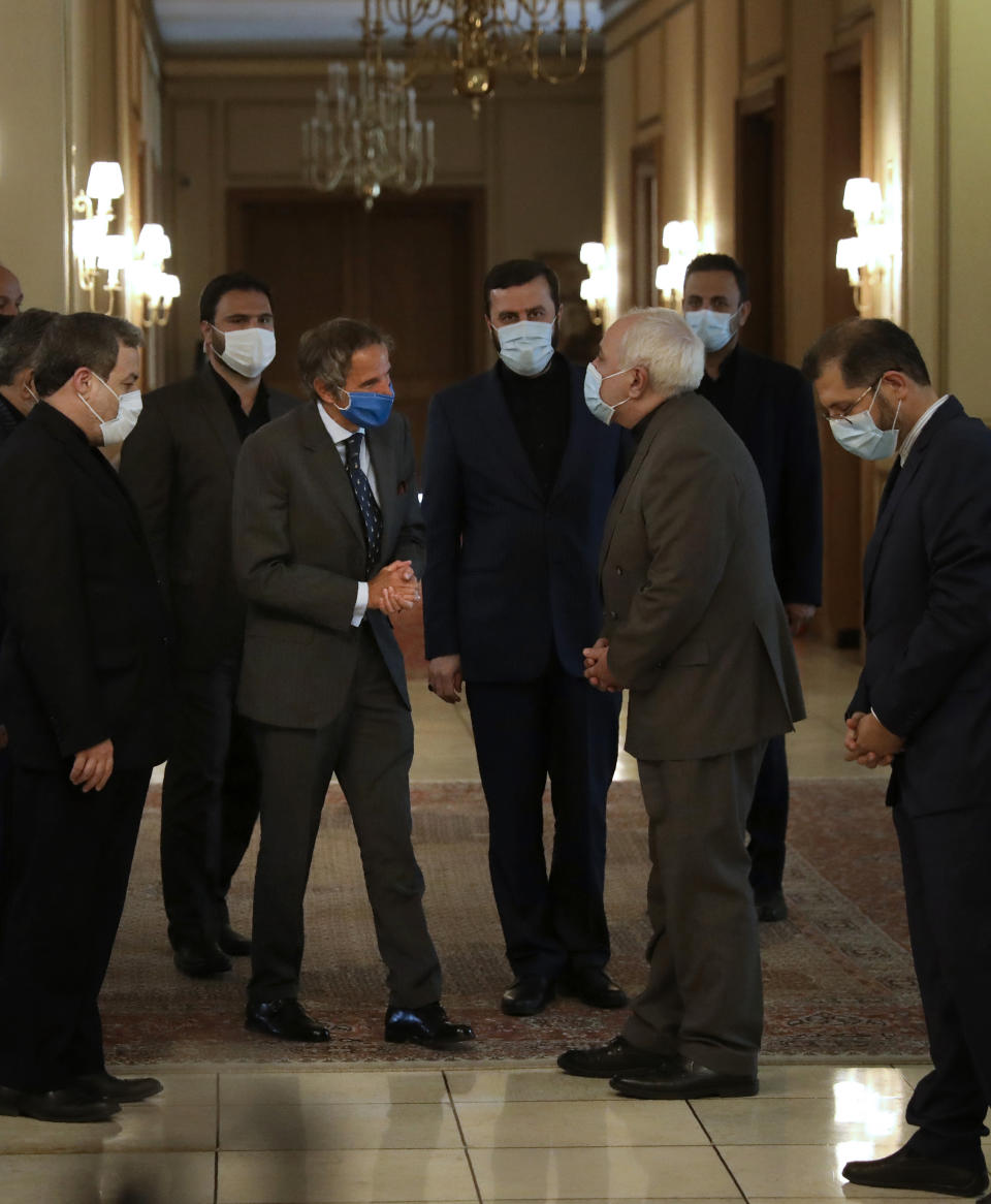 Iran's Foreign Minister Mohammad Javad Zarif, second right, welcomes Director General of International Atomic Energy Agency, IAEA, Rafael Mariano Grossi for their meeting in Tehran, Iran, Tuesday, Aug. 25, 2020. Grossi arrived in Iran on Monday to press for access to sites where authorities are thought to have stored or used undeclared nuclear material. (AP Photo/Vahid Salemi)