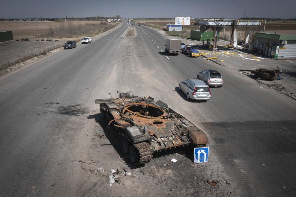 FILE -A Russian tank destroyed in recent fighting is seen on a road to Kyiv, Ukraine, Friday, April 15, 2022. On Friday, April 22, 2022, The Associated Press reported on stories circulating online incorrectly claiming a photo of a woman in a military uniform shows a “Ukranian beauty” who “blew up 52 invading Russian tanks.” (AP Photo/Efrem Lukatsky, File)