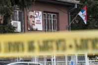 A poster of Kosovo Serb politician Oliver Ivanovic hangs on the wall outside his office in Mitrovica where he was shot dead