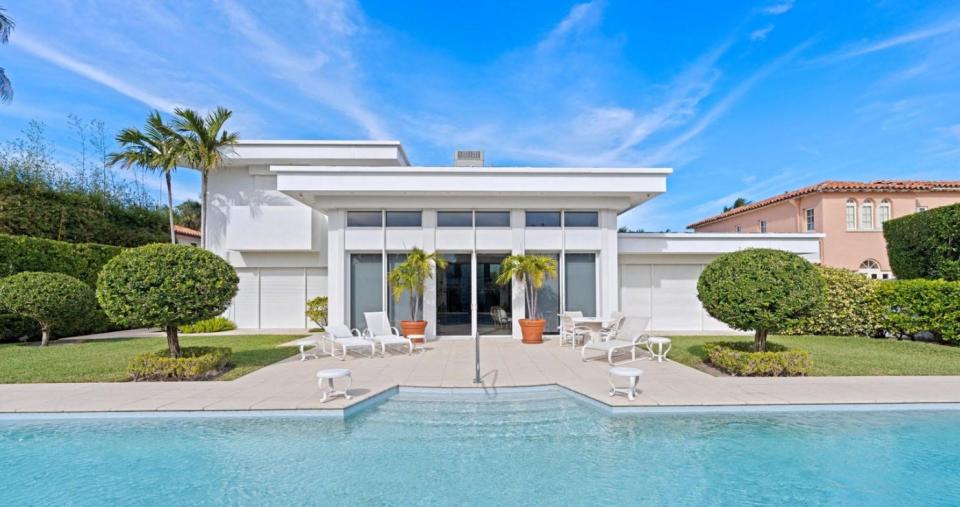 A contemporary-style Palm Beach house at 150 Dunbar Road faces a swimming pool, which the residence shares with the compound's guesthouse at 151 Atlantic Ave. The North End property is listed at $31.85 million.