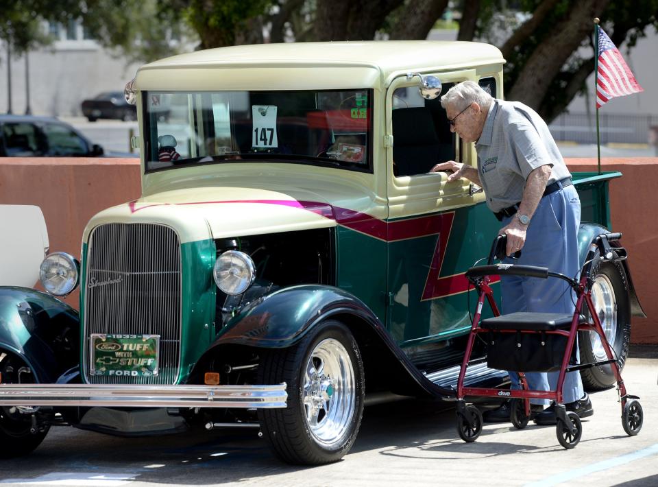 Andrew Bosko looks at a 1933 Ford truck during a car show put on by the Lakeland Cruisers Classic Car Club in Lakeland in 2016. The group holds car shows every Friday, most recently at Lakeside Village.
