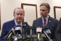 Reggie Whitten, left, one of the state's attorneys in the Opioid Lawsuit, answers a question during a news conference following the announcement of the judge's decision in Norman, Okla., Monday, Aug. 26, 2019. Whitten lost his son, who battled opioid addiction. At right is Oklahoma Attorney General Mike Hunter. (AP Photo/Sue Ogrocki)