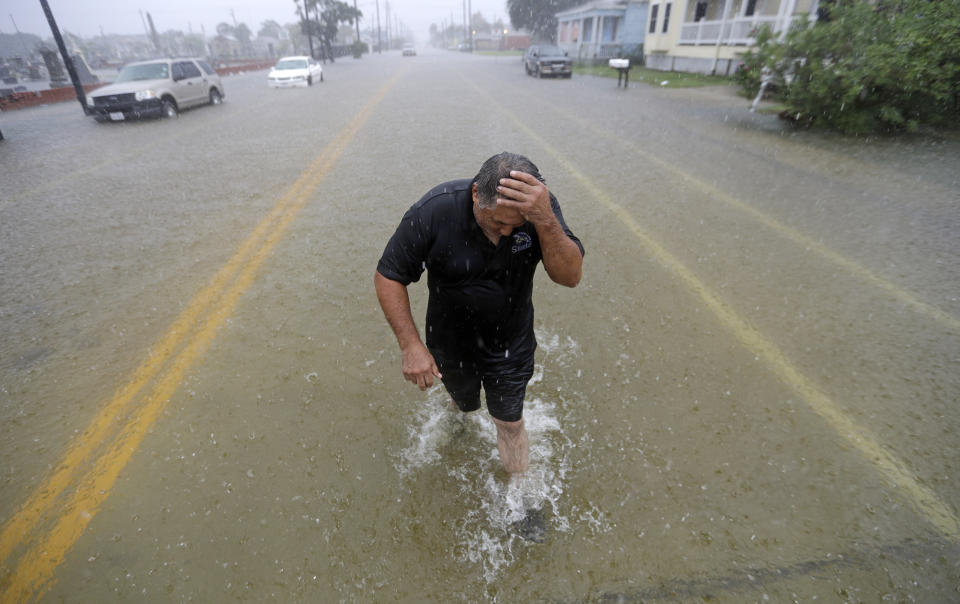 Angel Marshman wades through floodwaters from Tropical Depression Imelda after trying to start his flooded car Wednesday, Sept. 18, 2019, in Galveston, Texas. (AP Photo/David J. Phillip)