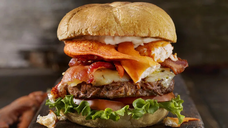 Gourmet burger with lobster, bacon, and cheese