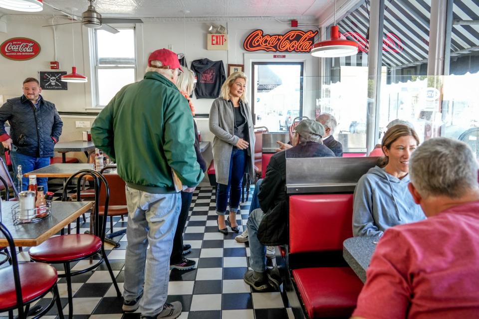 Republican gubernatorial candidate Ashley Kalus talks with diners at Gary's Handy Lunch in Newport, a few blocks from her house.
