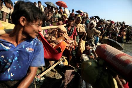 Rohingya refugees who fled from Myanmar wait to be let through by Bangladeshi border guards after crossing the border in Palang Khali, Bangladesh October 16, 2017. REUTERS/ Zohra Bensemra