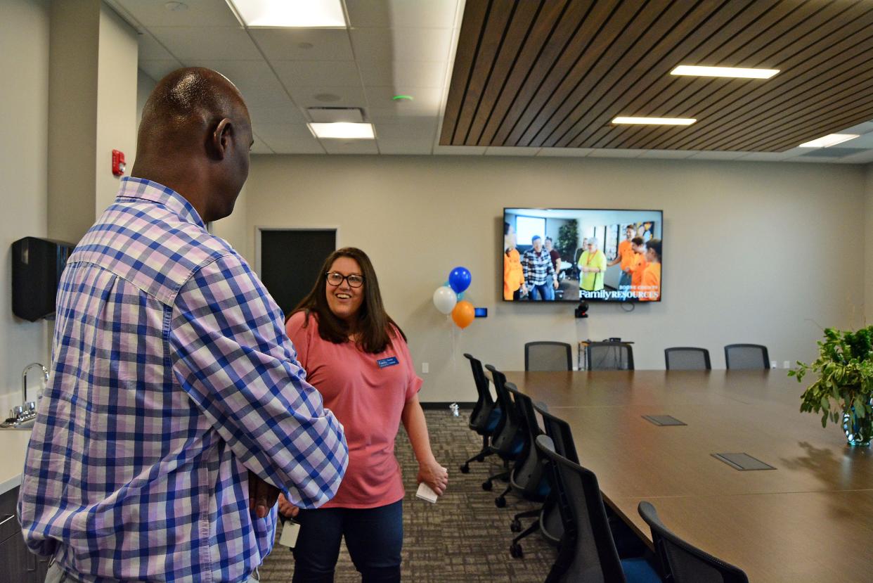 Boone County Family Resources Center staff member Rachel Turnbull, right, leads a tour Thursday of the social service agency's new offices on West Ash Street. 