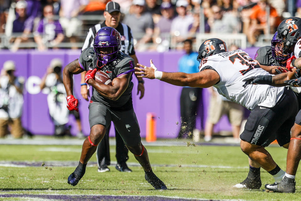 FORT WORTH, TX - OCTOBER 15: TCU Horned Frogs running back Emari Demercado (3) runs through the line of scrimmage during the game between the TCU Horned Frogs and the Oklahoma State Cowboys on October 15, 2022 at Amon G. Carter Stadium in Fort Worth, Texas. (Photo by Matthew Pearce/Icon Sportswire via Getty Images)
