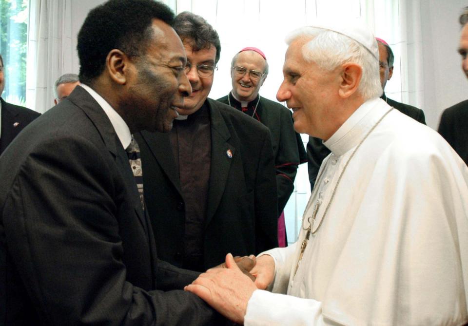 Pope Benedict XVI shakes hands with Pele during their meeting August 20, 2005 in Cologne, Germany. (Getty Images)