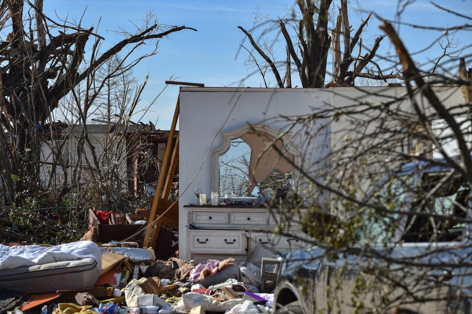 A house with only a chest of drawers sits in the morning sunlight in Rolling Fork on Monday.