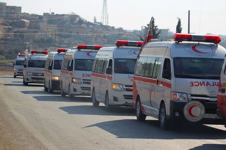 Syrian Arab Red Crescent ambulances evacuate fighters and civilians from the two besieged Shi'ite towns of al-Foua and Kefraya in the mainly rebel-held northwestern province of Idlib, Syria December 28, 2015. REUTERS/Ammar Abdullah