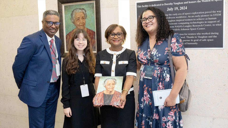 NASA Johnson Space Center director Vanessa Wyche (second from right) holds a portrait of 